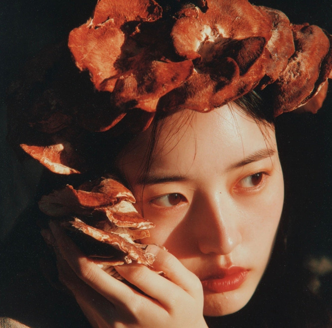 woman holding mushrooms to her face